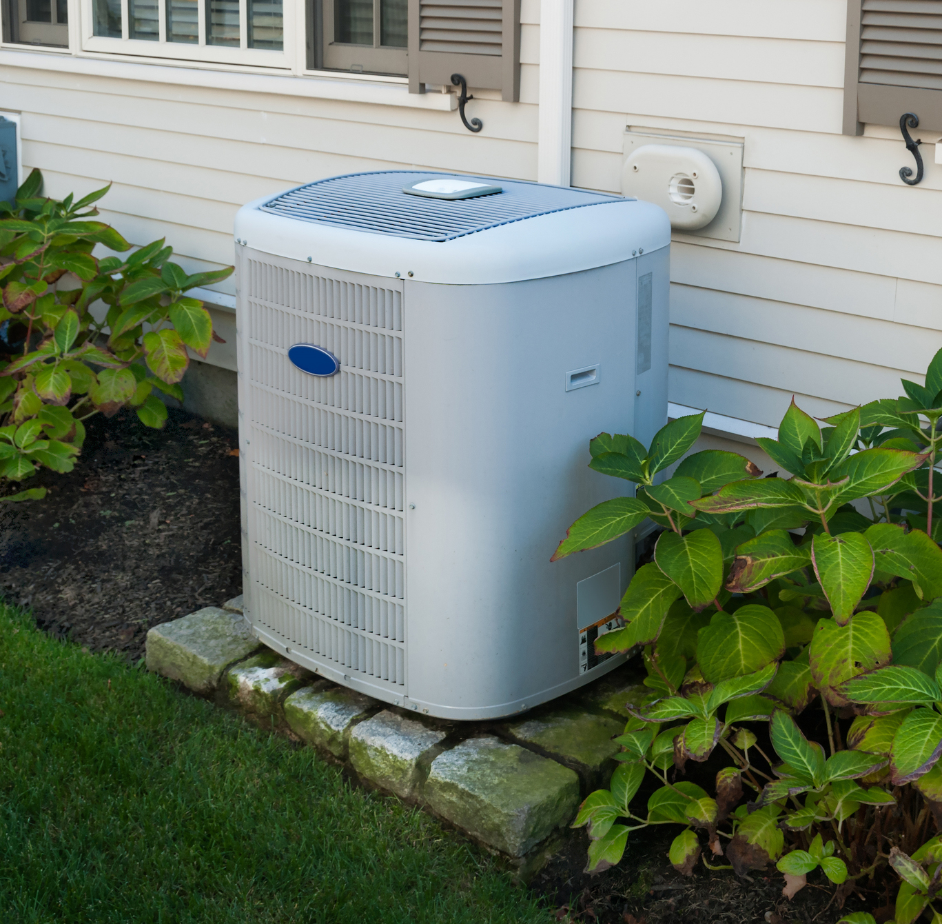 Heating And Air Conditioning Inverter On The Side Of A House