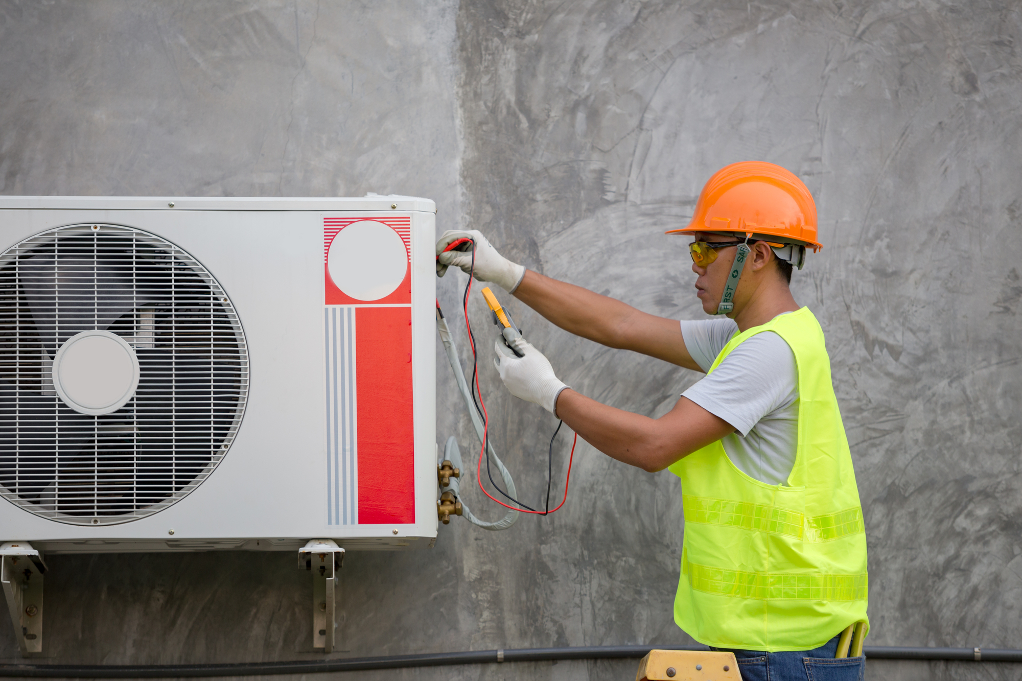 Male Repairman Is Checking The Air Conditioner