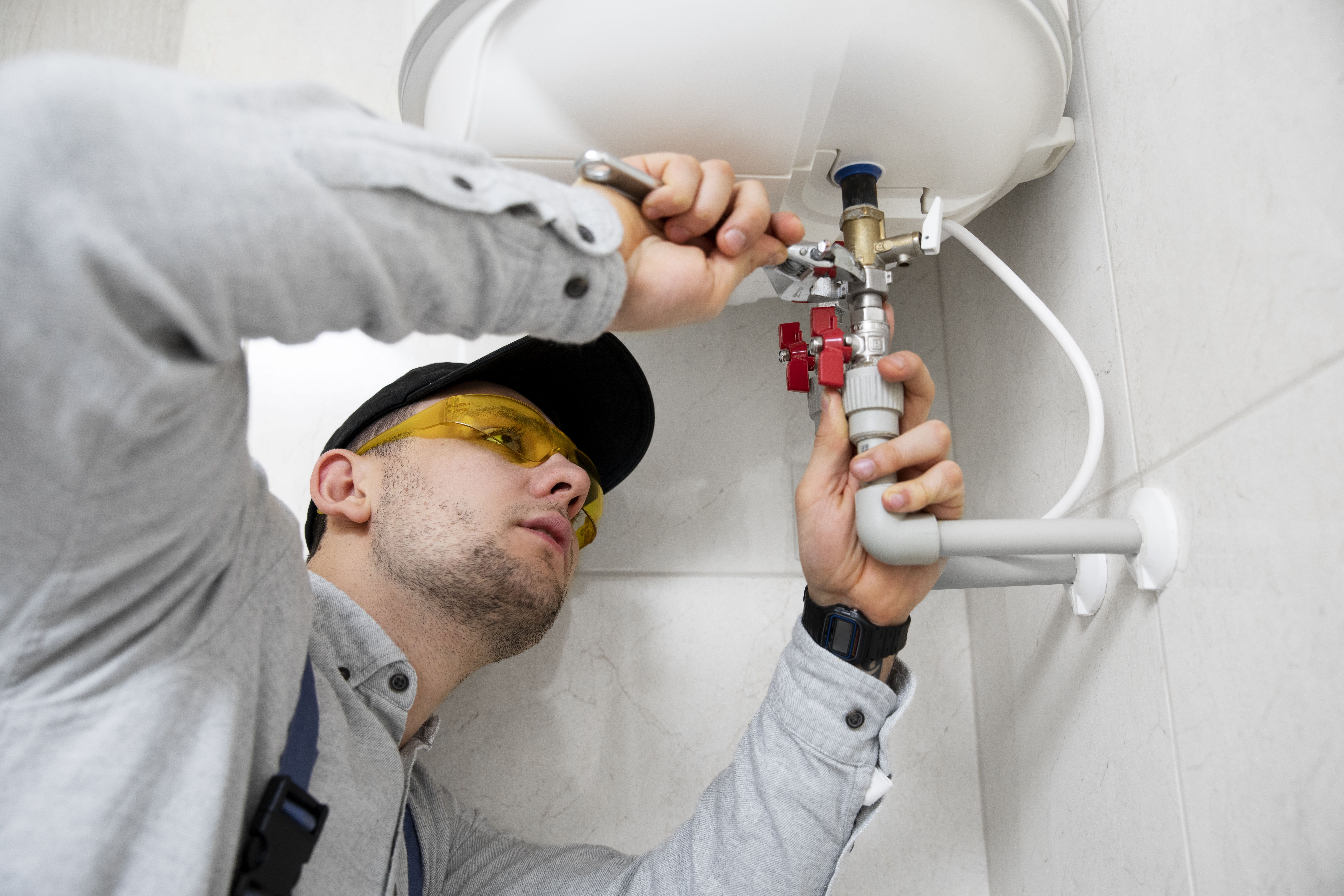 Technician Servicing An Hot-water Heater