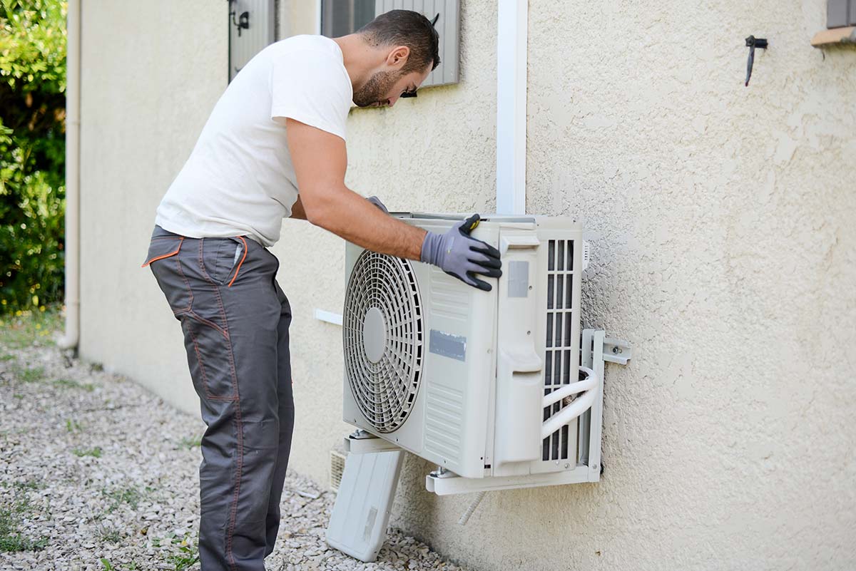 Hvac Tech On Roof Top Checking A Condenser Unit